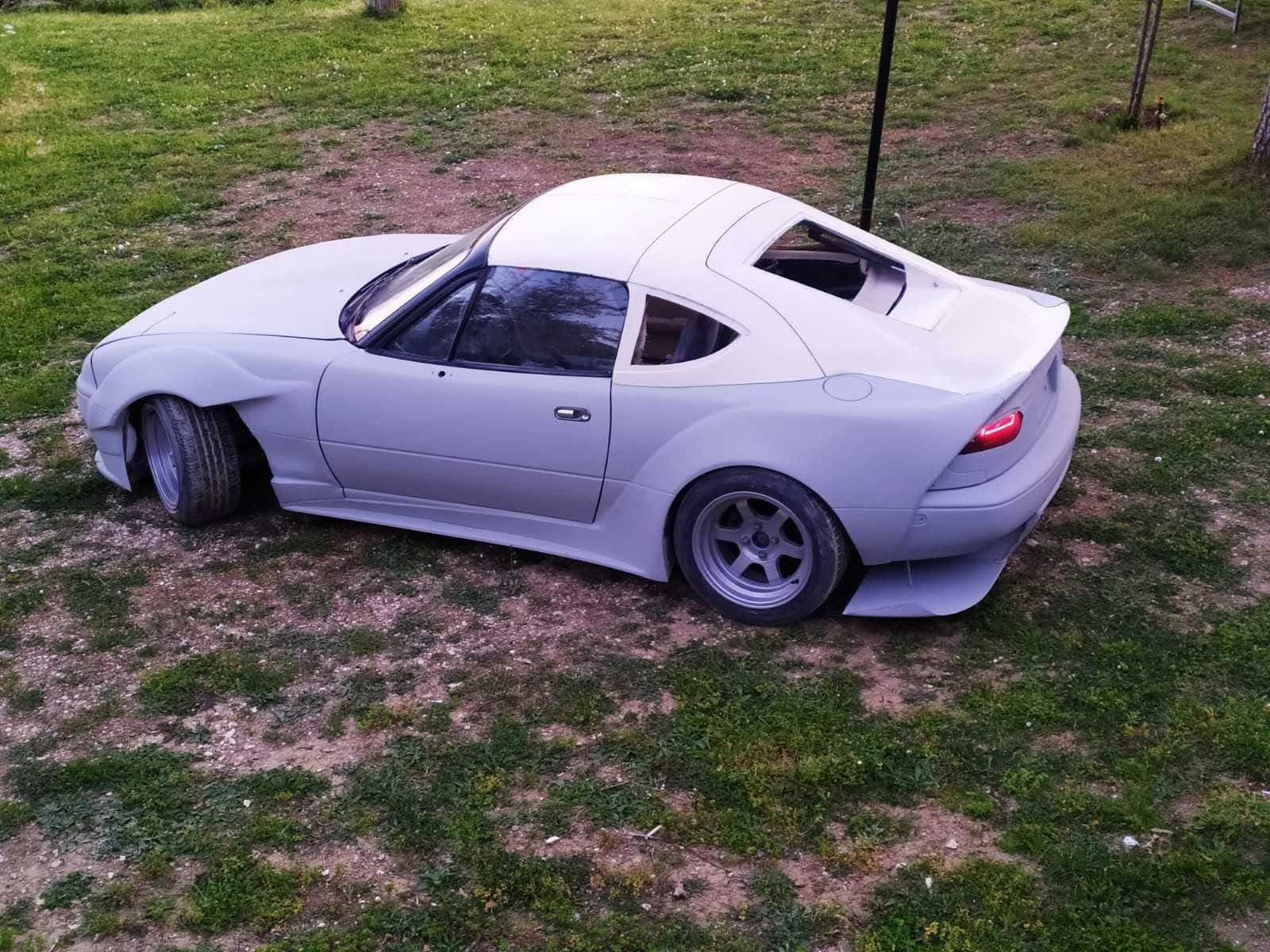 NB Miata fastback roofline detail — showing the sloping rear glass transition